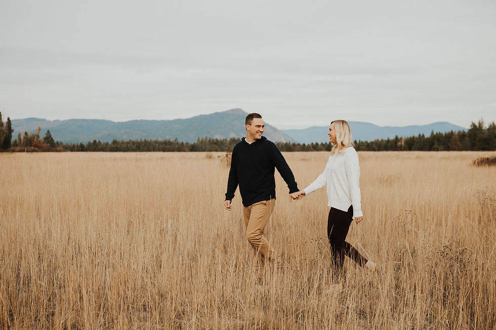 engagement session in north idaho with mountains, fields, and lake