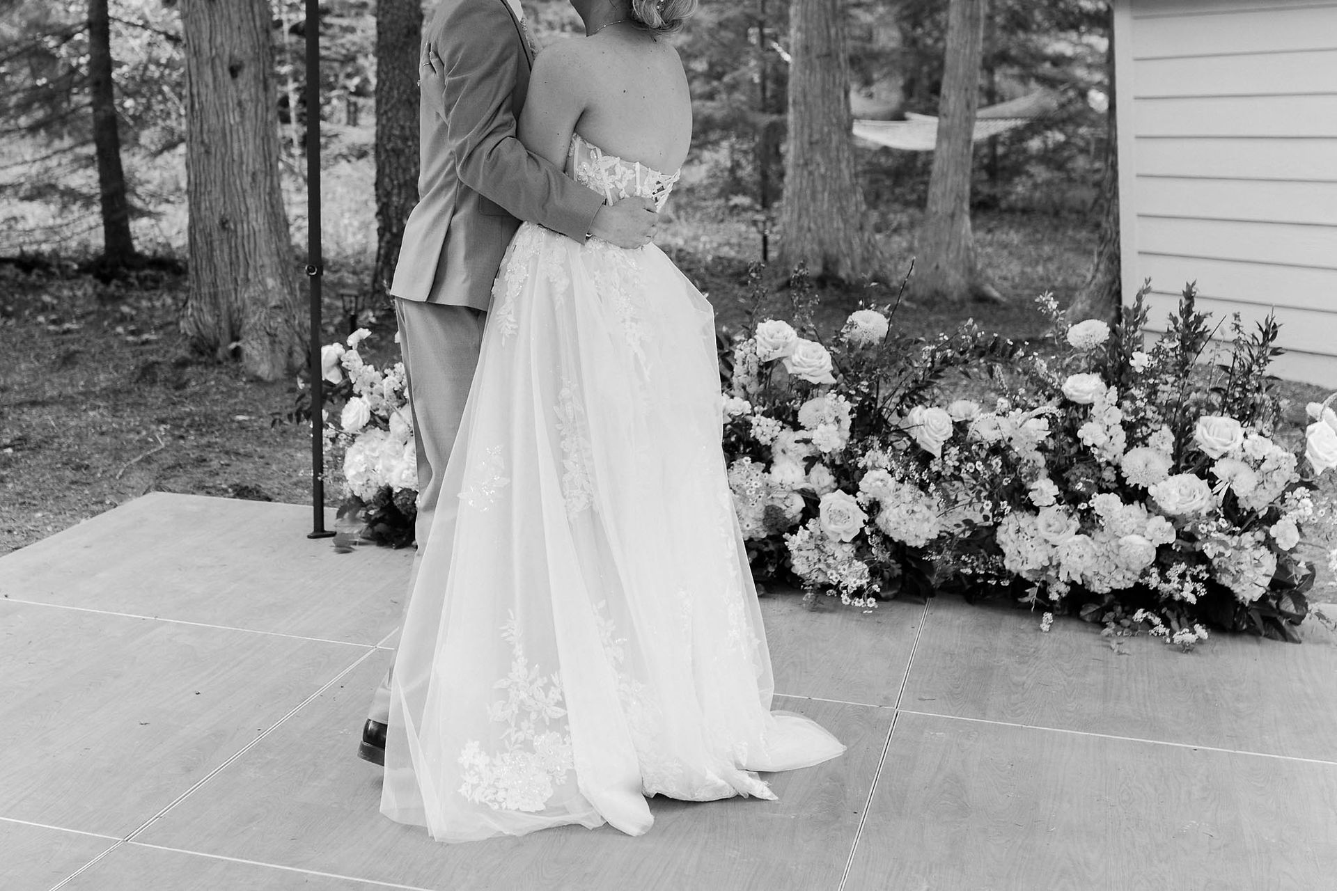 bride and groom dancing on a dancefloor outside