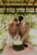 a couple cutting their wedding cake