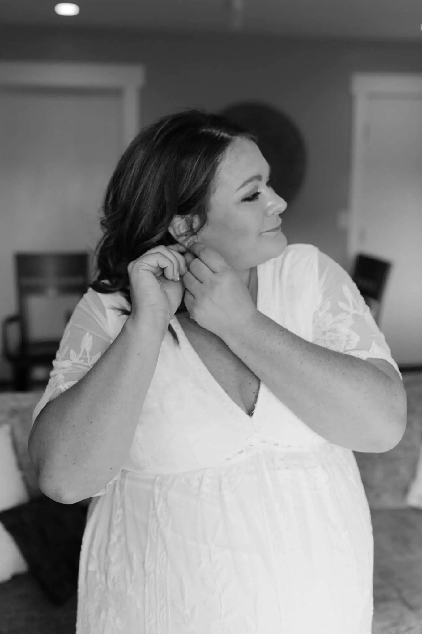 bride putting in earrings