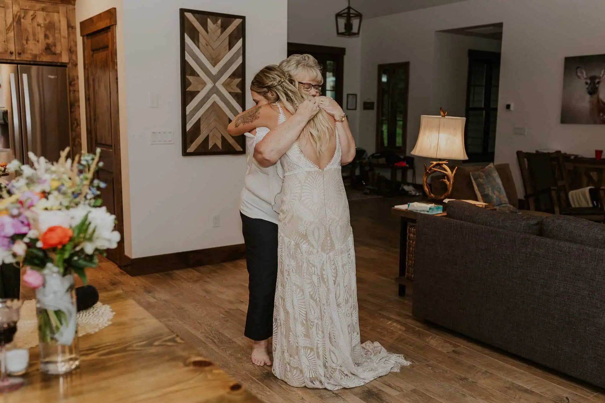 bride hugging her mom while dancing