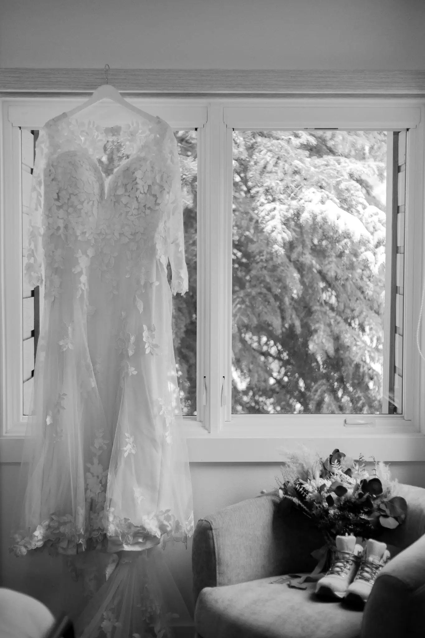 a wedding dress hanging from a window