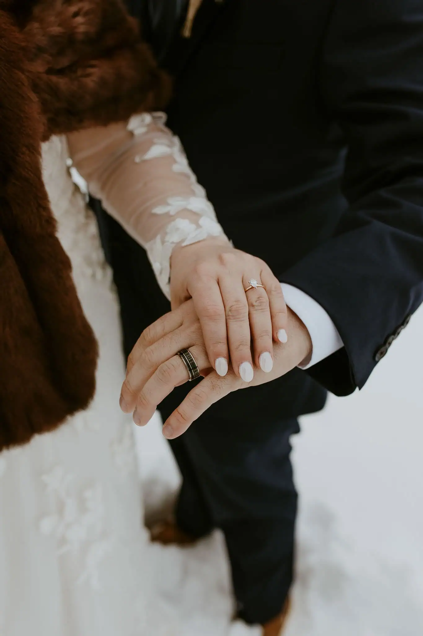 bride and groom wearing their wedding rings