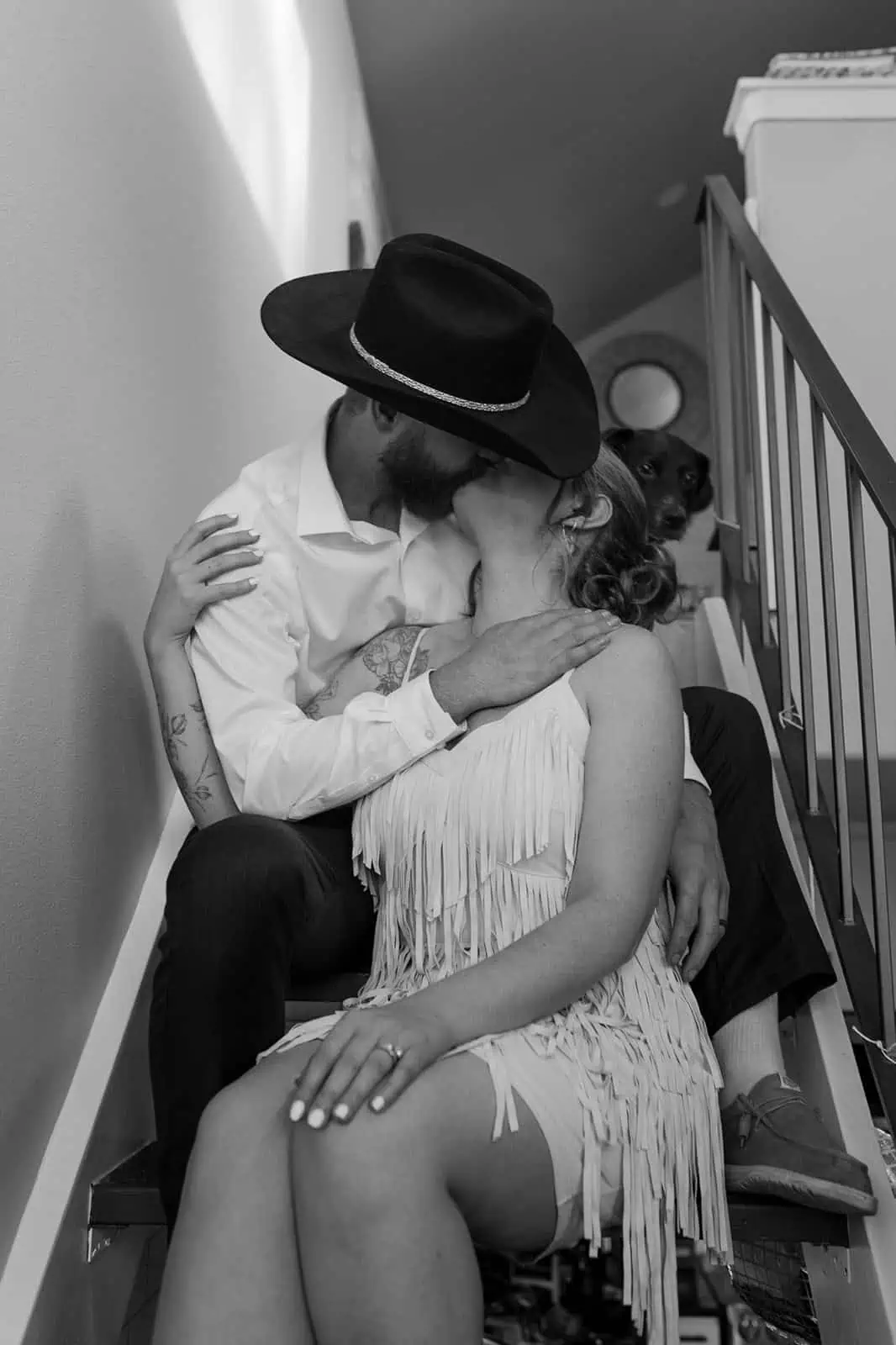 groom kissing bride on stairs