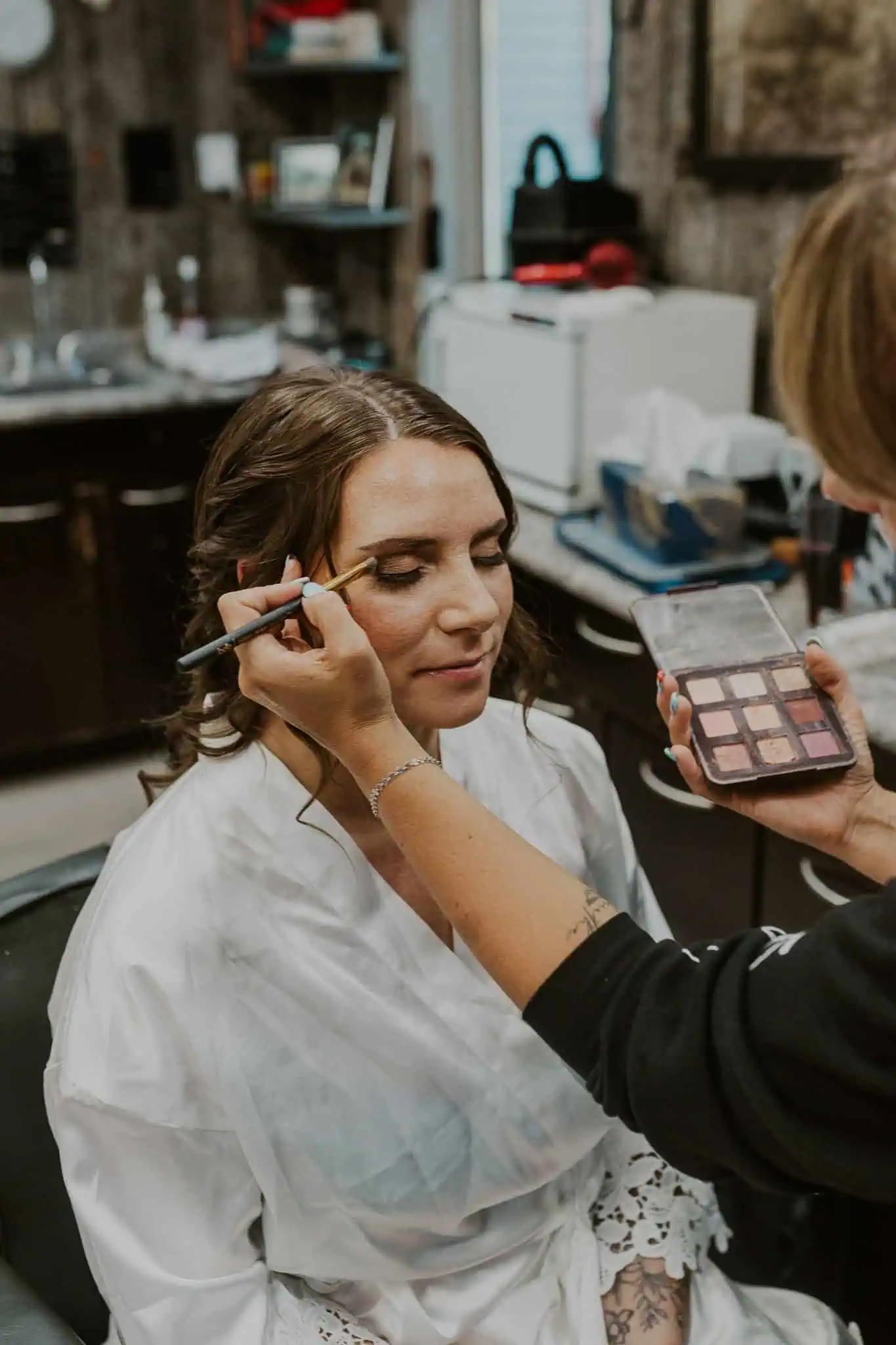 a bride getting her makeup done
