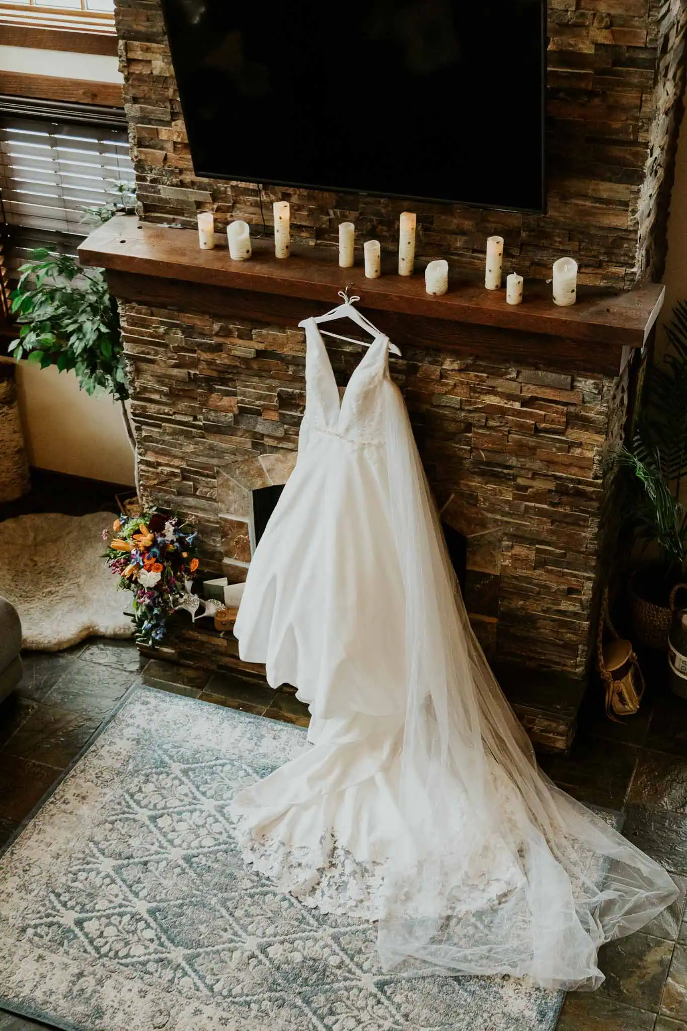 a wedding dress hanging on a fireplace