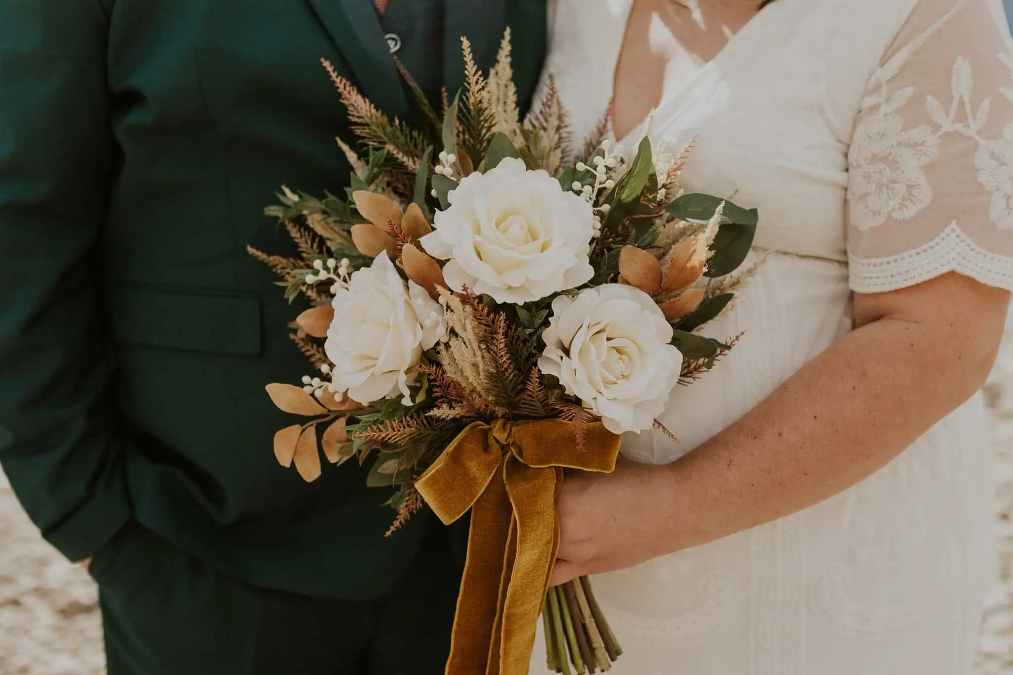 close up photo of a white and orange flower bouquet