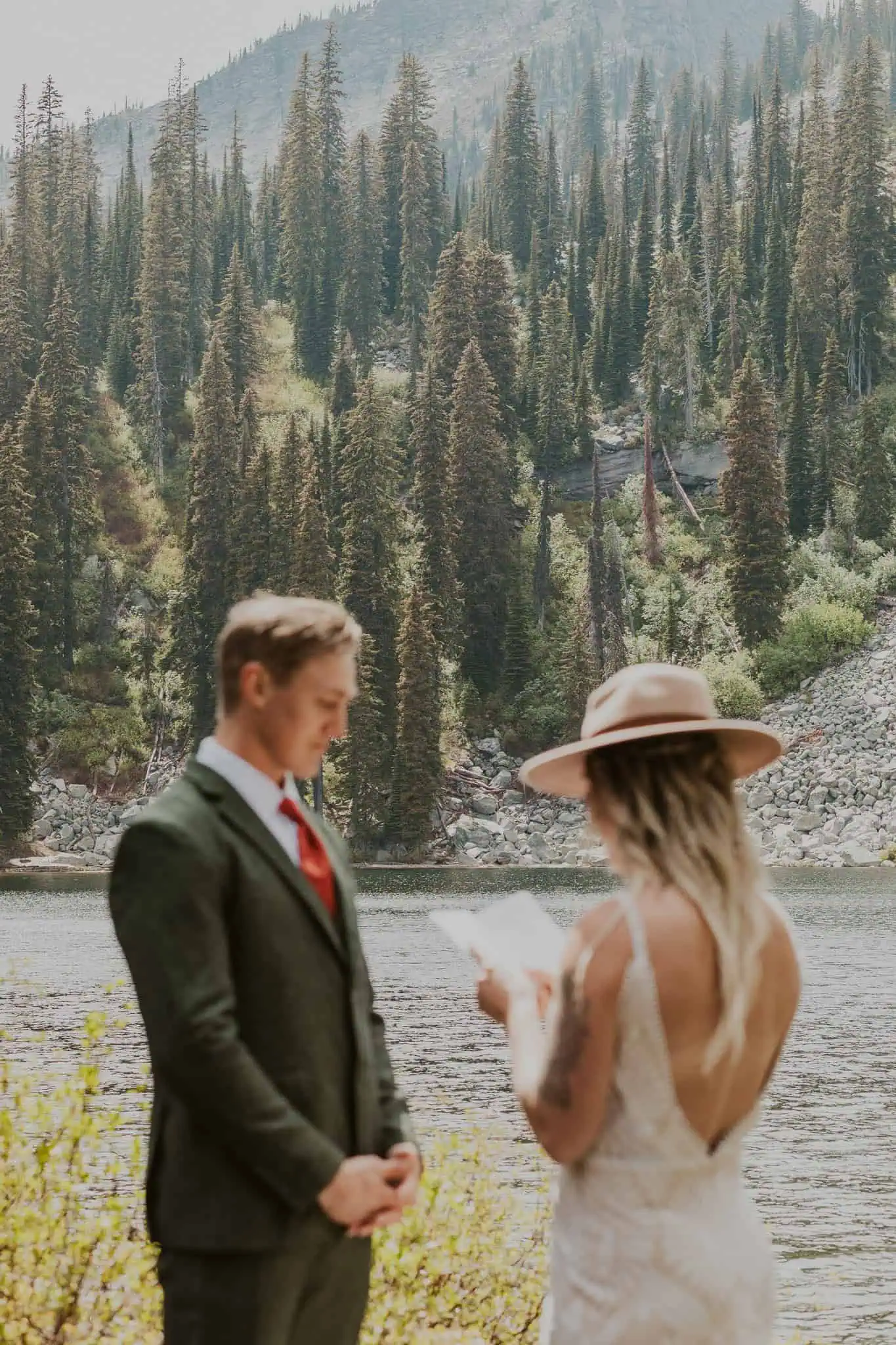 a couple reading vows in the mountains