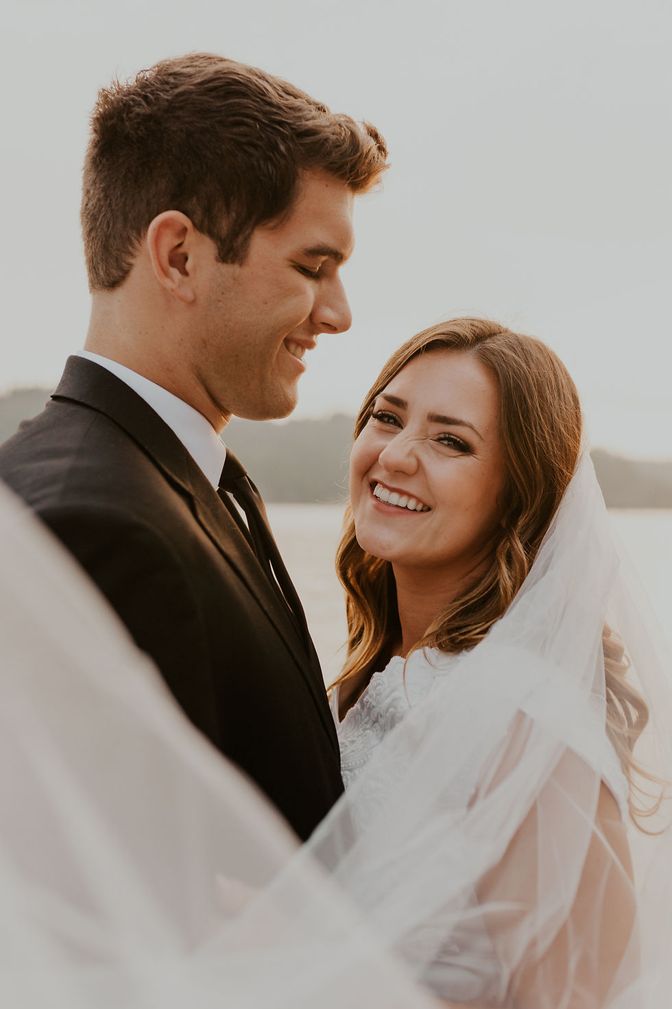 dreamy sunset lake bridals on lake coeurdalene north idaho, bride and groom adventure bridals on the water golden hour sunset dock and wake surfing photos, bridals on a boat