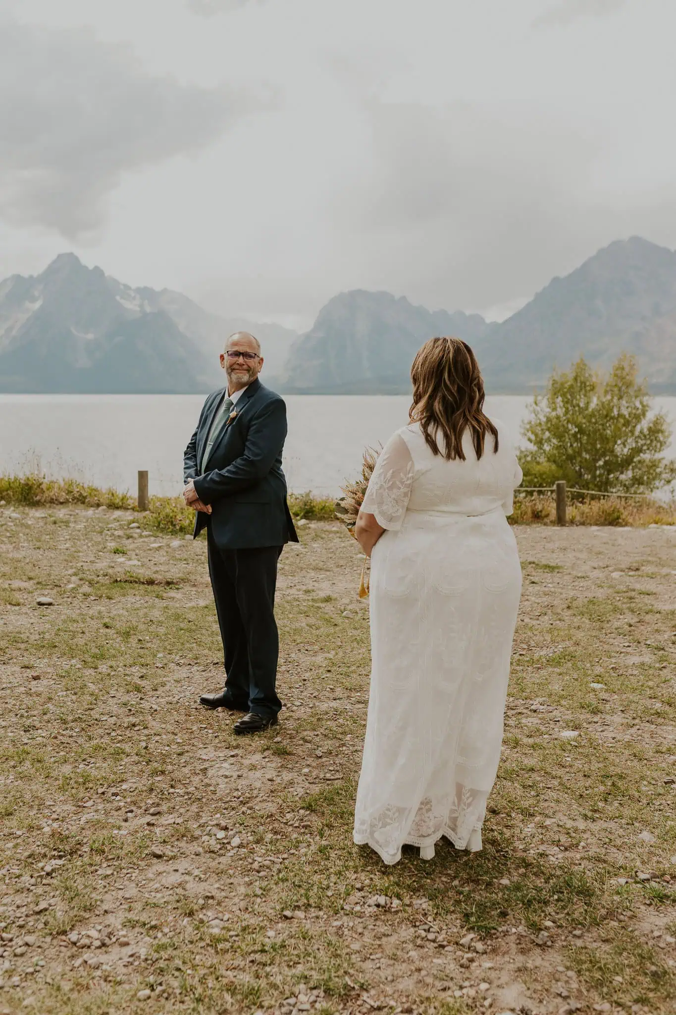 bride having first look with dad at colter bay swim beach