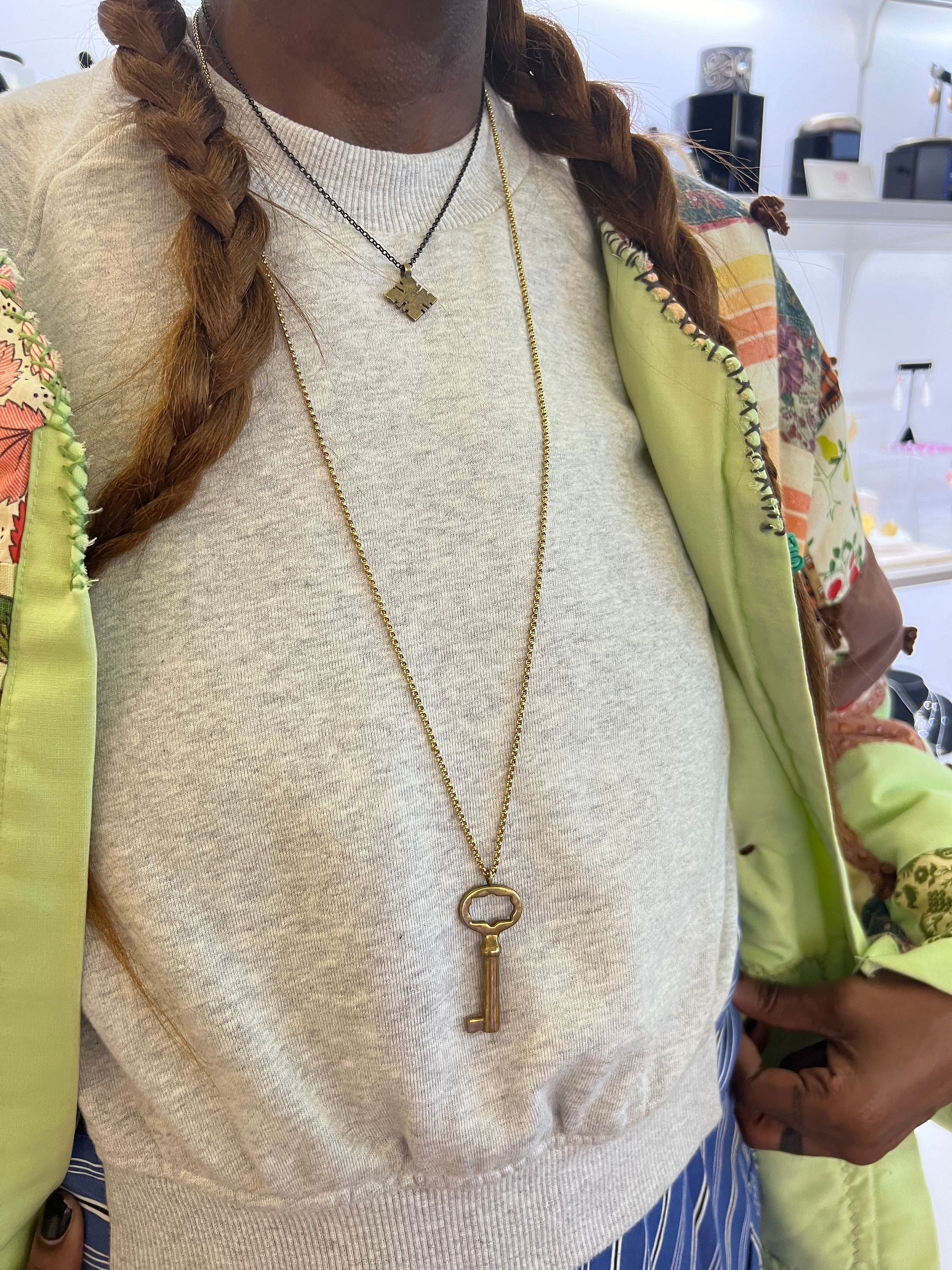 sunlit fine jewelry's key pendant and Ethiopian cross pendant layered together
