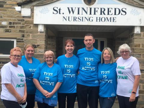 volunteers infront of house all wearing matching "this is active" shirts