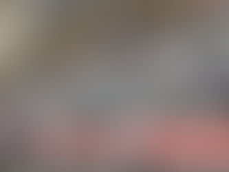 Children in team vests in discussions with a coach. they are in a football field