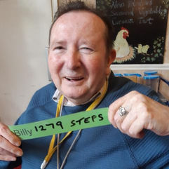 Billy holding up a sign with his step count