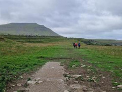walkers on moors in the distance