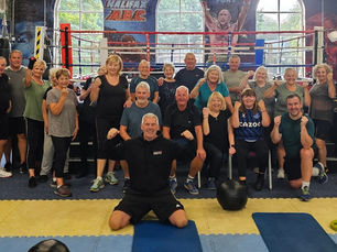 photograph of several members of Halifax Boxing Club in front of the ring.