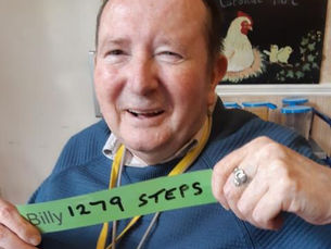 Active walker Billy holding up his step count