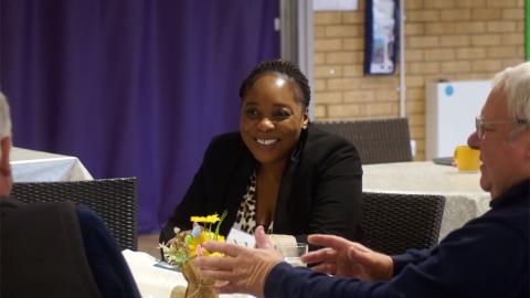 woman smiling sat down at a party