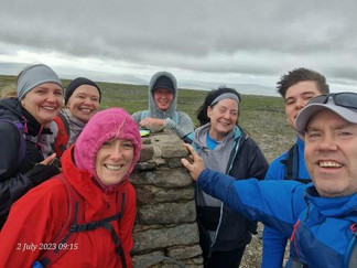 Walkers celebrating by stone pile