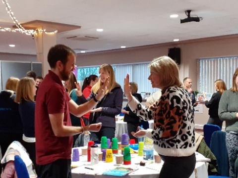 a room full of people engaging in activities