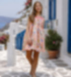 Girl in pink floral dress walking in Santorini