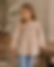 Girl in embroidered beige top and blue jeans