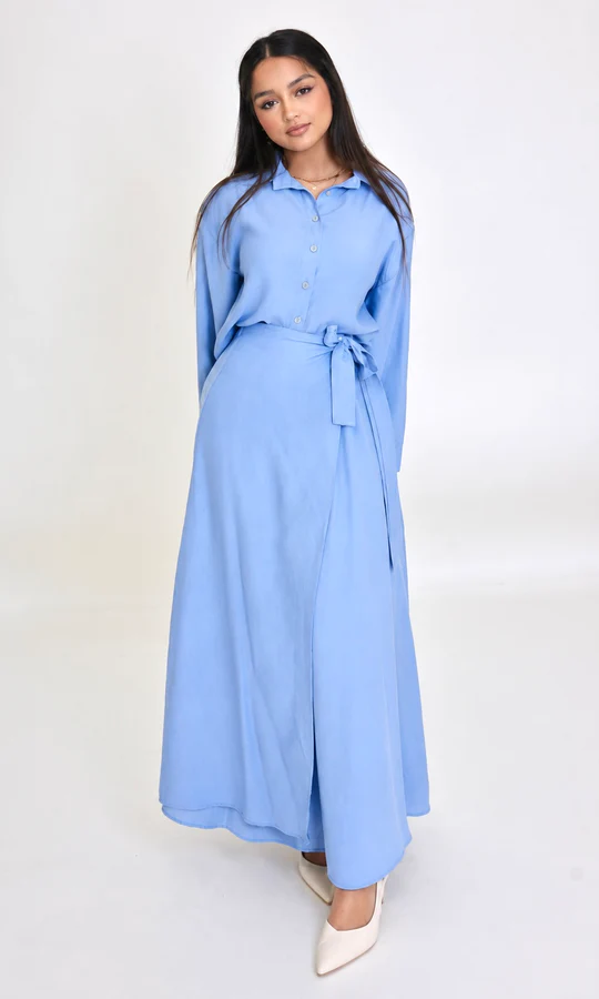 a woman wearing a blue lana set dress by modest barbie