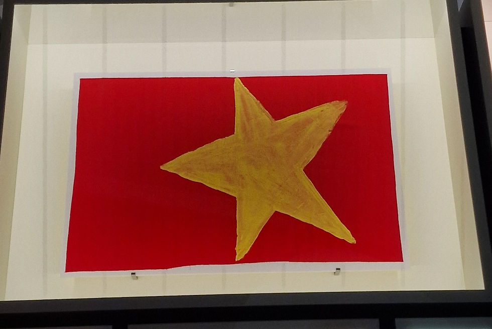 a red flag with a yellow hand painted star