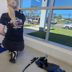 Commercial window tint being installed on shopfront glass in Mount Isa Queensland