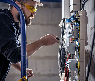 a-male-electrician-works-in-a-switchboard-with-an-2025-03-13-03-08-57-utc.jpg