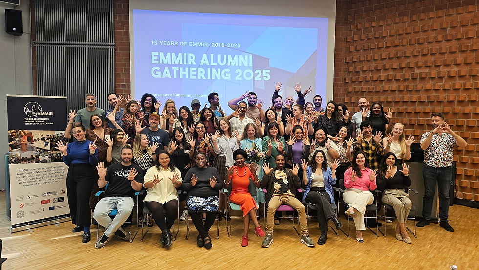 EMMIRians holding up fingers for the umber of their edition.