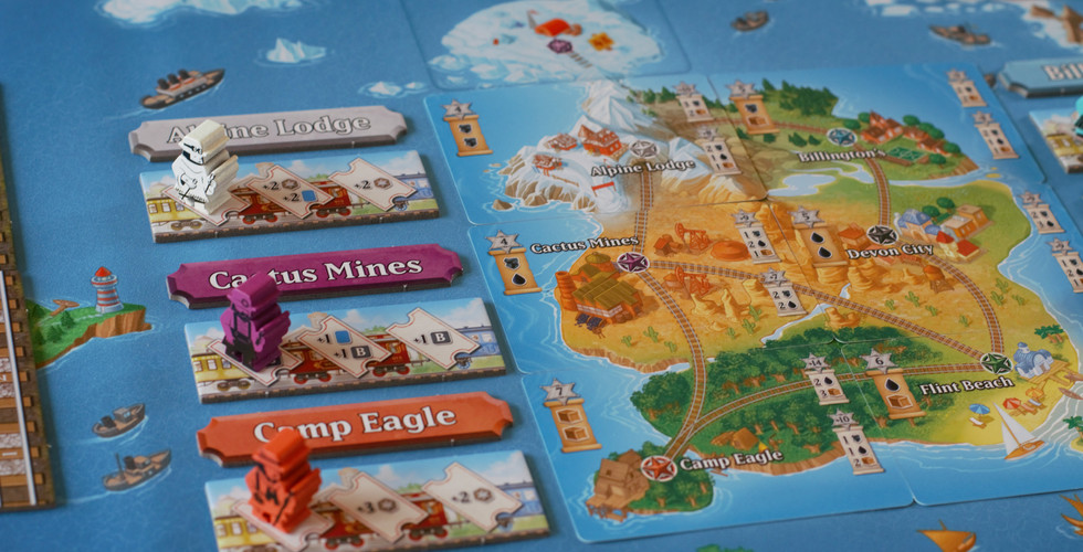 A closeup of island locations in the game Isle Of Trains All Aboard with screen printed meeples of corresponding colours on them