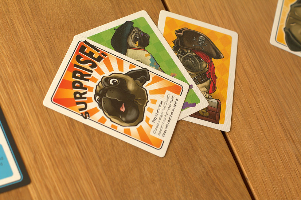 A Surprise card from the game Pugs in mux. There is the head of a slightly shocked looking pug with a starburst in the background and Surprise across the top in large letters. There is text explaining the card at the bottom.