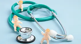  Paediatric healthcare concept with a stethoscope and miniature baby figurines symbolizing neonatal care, 