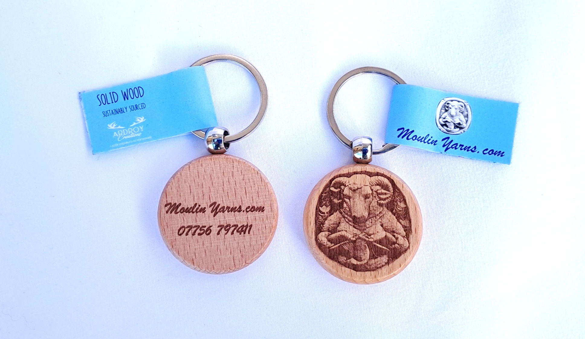 round wooden keyring with moulin yarns logo and phone number