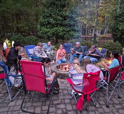 2025 Youth Gathering around firepit at the Deaton's.jpg