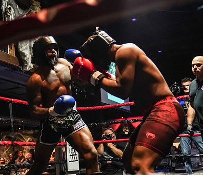 two kickboxers fighting at a jackhammer promotions event.