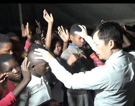 Believers with hands raised in worship at a Healing The Nations service