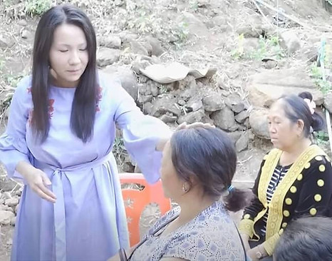 Woman receiving prayer at a Healing The Nations Ministries event