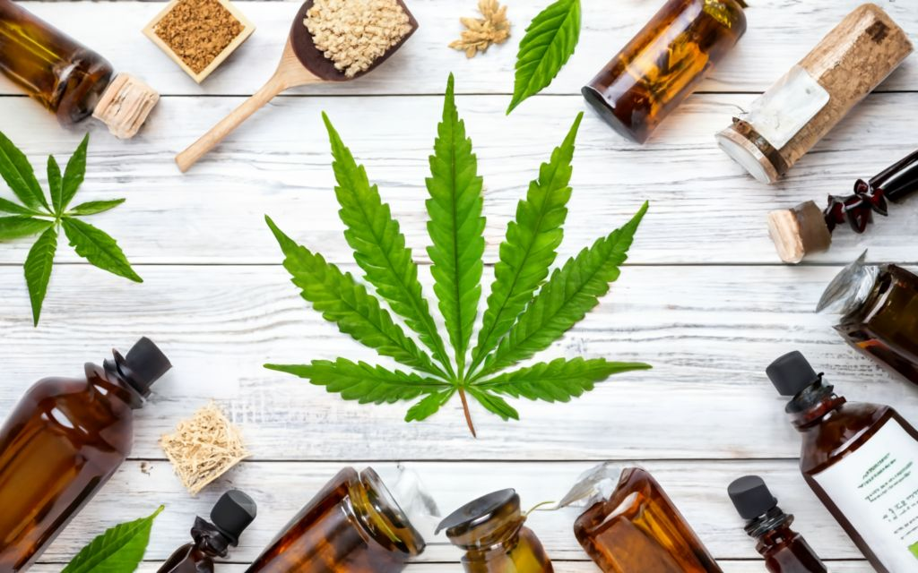 Cannabis leaf in in the center different kinds of hemp products around., typography