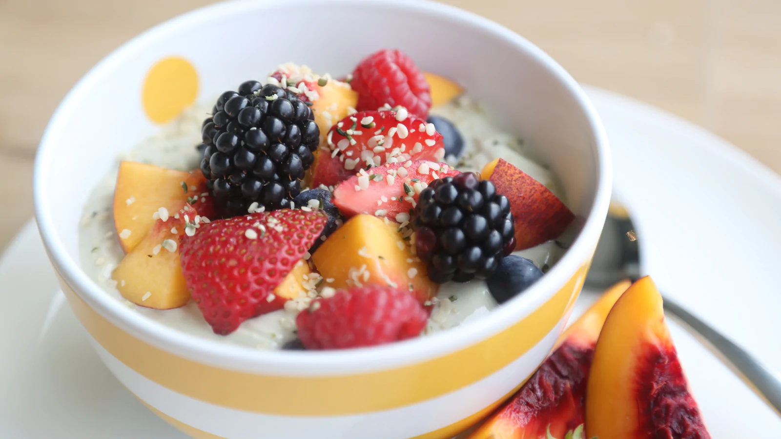 Hemp yogurt in a bowl with blueberry, strawberries and fruits