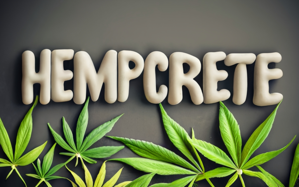 Hempcete word made of hempcrete, cannabis leaves below