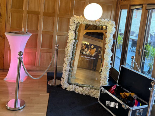 Wedding magic mirror booth decorated with flowers and lights