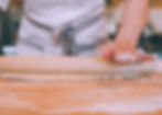 Hand of Bijou bakery owner Jeniece hand-rolling dough