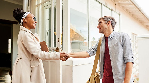 Two-people-shake-hands-outside-of-a-home-while-conducting-campaign-canvassing.-copy.jpg