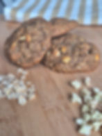 Thumbnail: Apple oat and cinnamon cookie, apple dices and oats scattered by the sides of the cookie