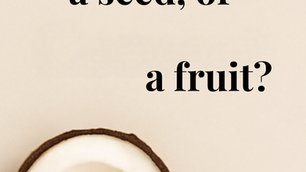 A half fresh coconut with a bowl of shredded coconut next to it