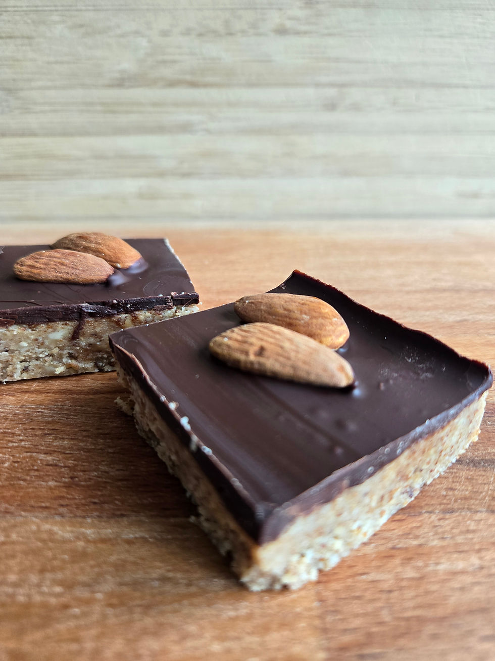 Two Almond Bars with chocolate topping and whole almond garnish