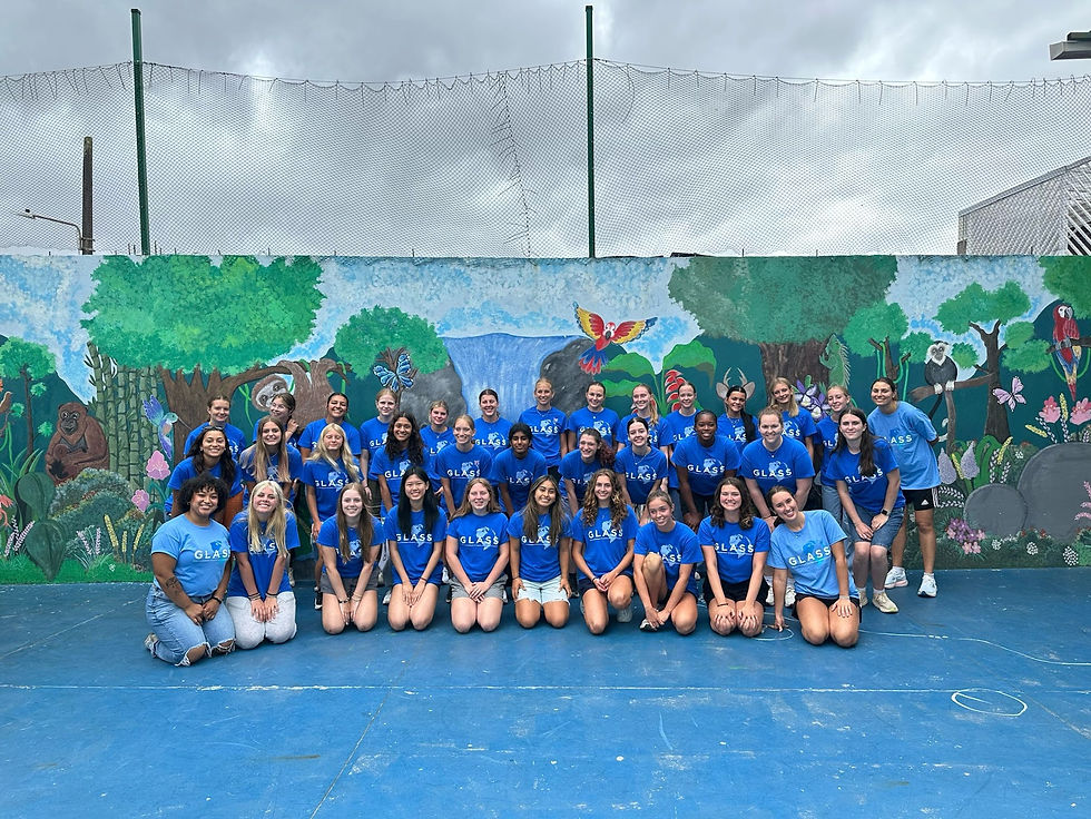 A group of GLASS athletes pose in front of a Costa Rican themed mural