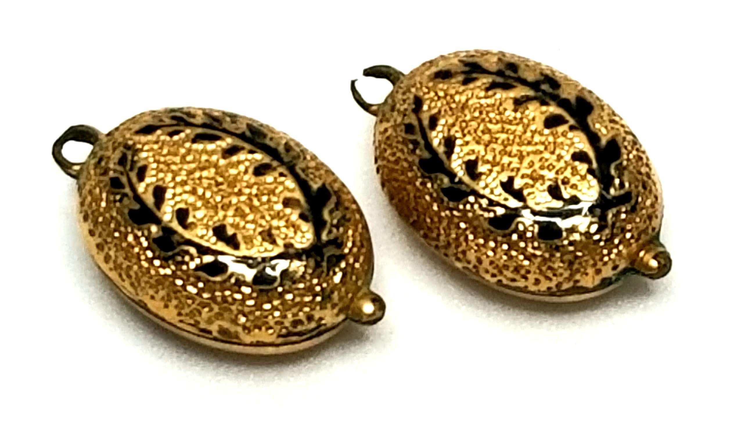 Designer by provenance, links (2) from bracelet, black inlay, gold tone.